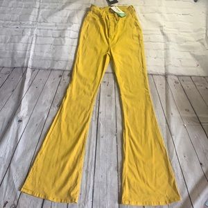 Brand NWT. Fashion nova bell bottom stretchy jeans. Mustard color size 7